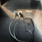 Bluetooth AUX adapter plugged into car audio port, showing USB and 3.5mm connections