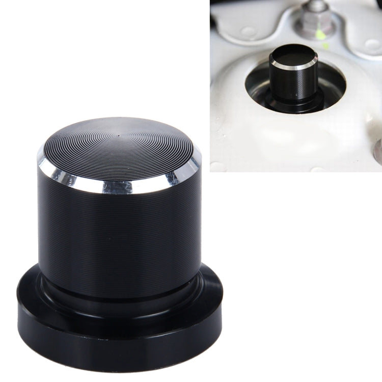 Black metal bump stop screw cap with ridged top and silver trim ring
