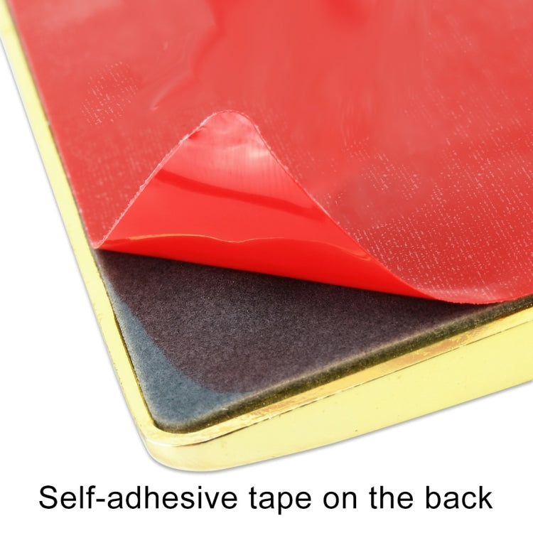 Self-adhesive tape on back of red rectangular metal sticker with gold border