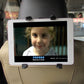 Tablet secured to a headrest with black adjustable mount brackets