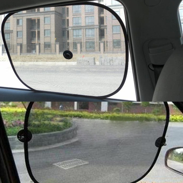 Installed pair of side window shades with dark fabric panels and suction cups