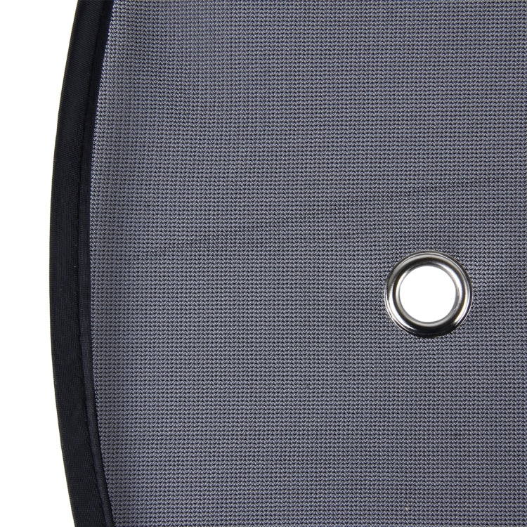 Car window shade grommet on black mesh panel with metal ring