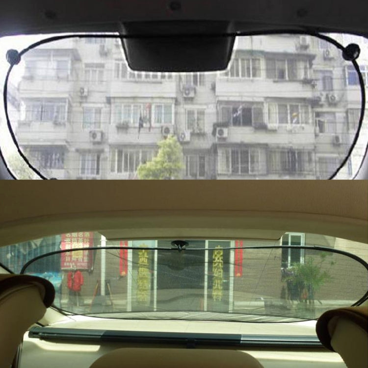 Rear car window shade stretched with suction cups on the glass