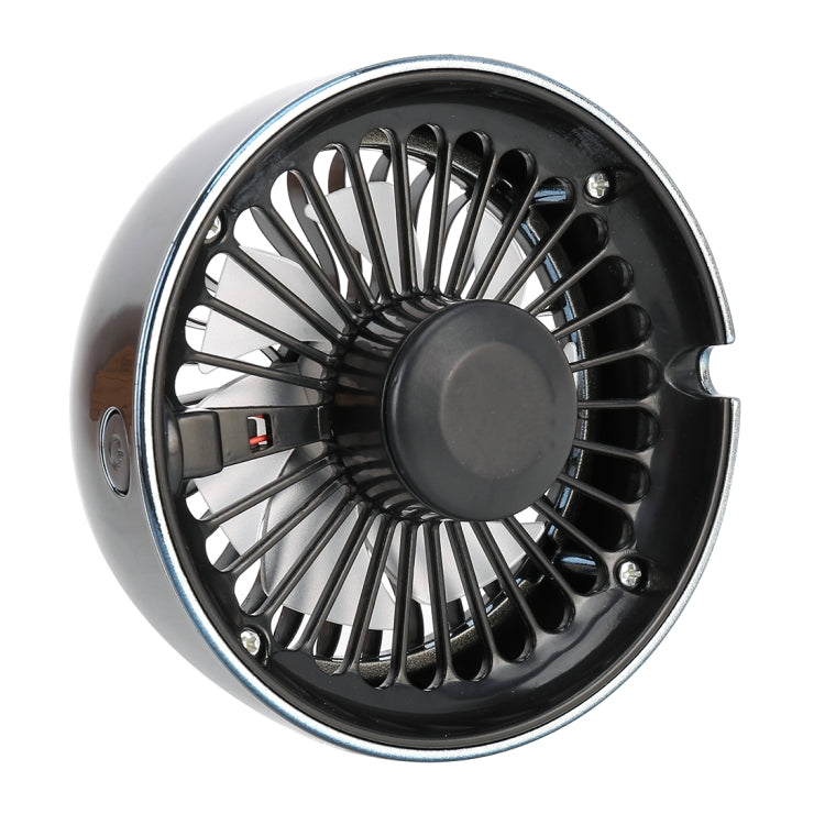 Silver-and-black portable car fan with front grille and central hub, side vented housing.
