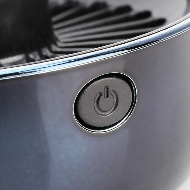 Close-up of fan control button with power symbol on black housing panel.