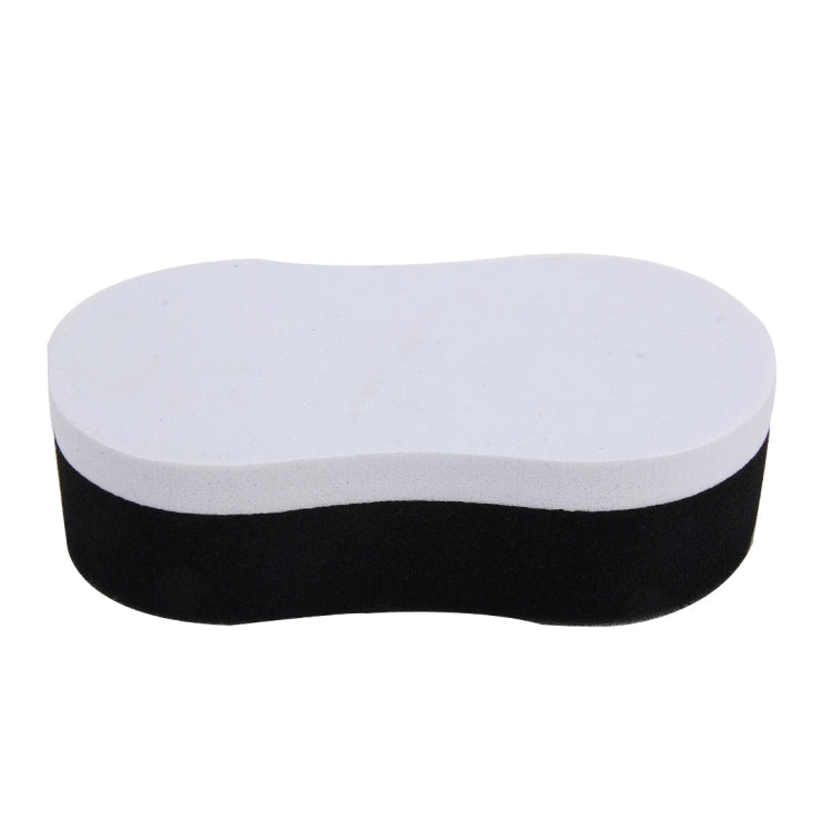 Two-tone waxing sponge, white top and black base, rounded curved shape