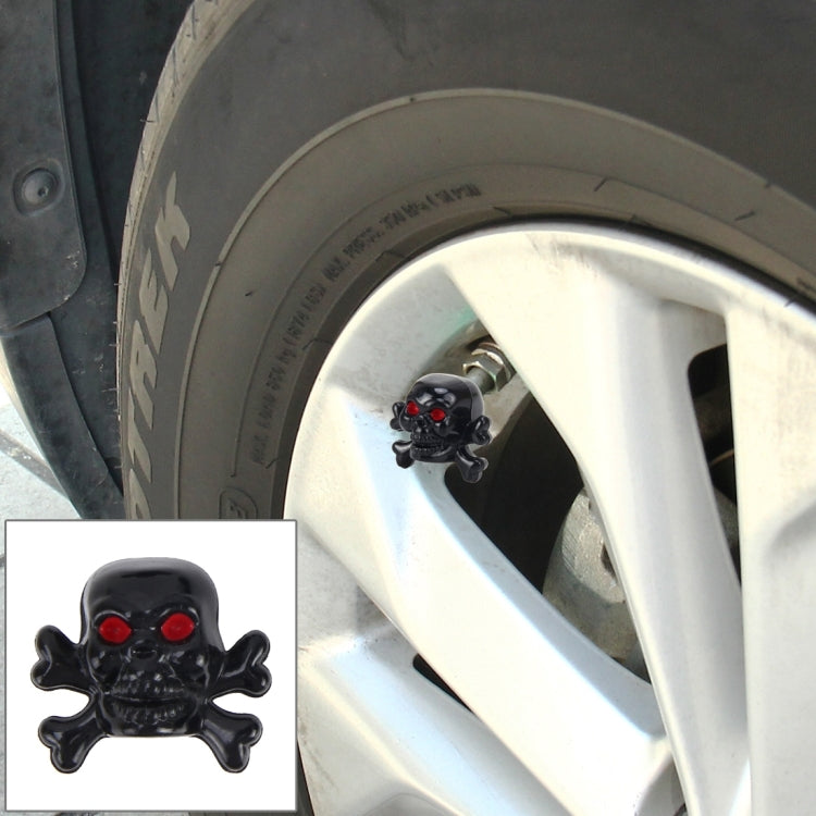 Black skull tire valve cap cover with red eye accents for valve stems