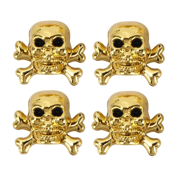 Set of four gold skull tire valve cap covers with black eyes