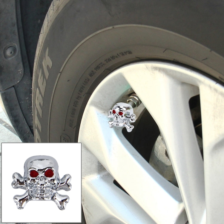 Silver skull tire valve cap cover with red eye accents for valve stems