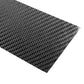 Diagonal close-up of black carbon-fiber patterned sticker sheet, glossy weave