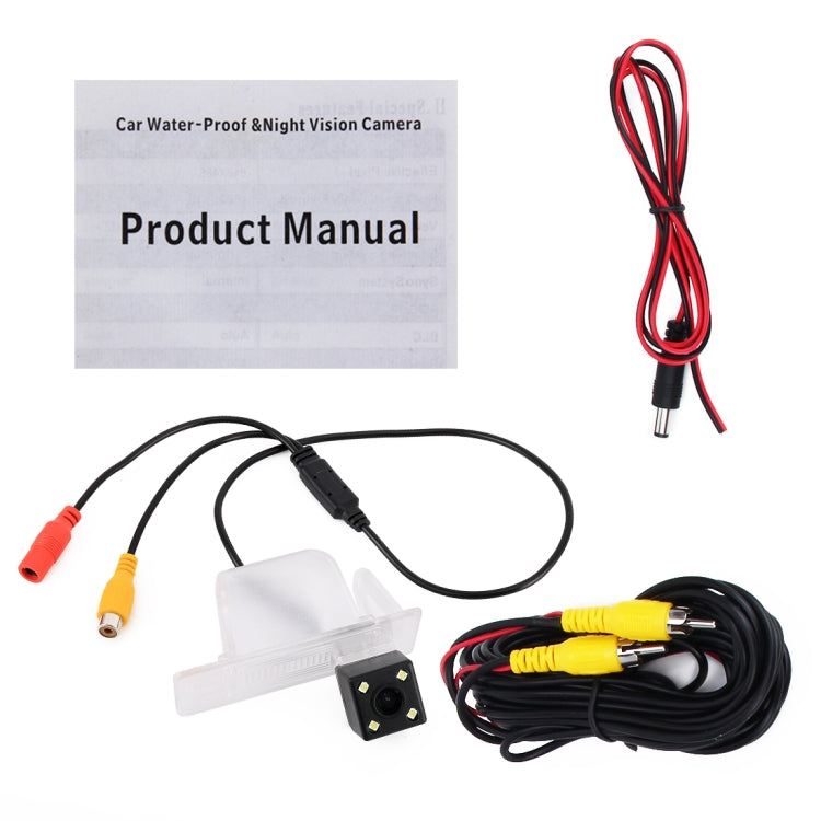 Car backup camera kit with clear license-plate camera, cable harness, and booklet