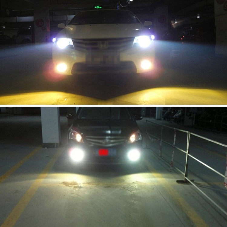 Car front view with bright HID xenon headlights on in a dim garage
