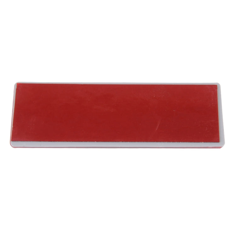 Red rectangular reflector lens with clear border and two mounting points
