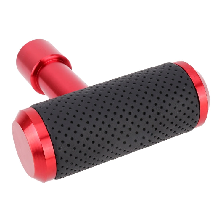 Red T-shaped gear shift knob with black perforated grip and angled red metal ends