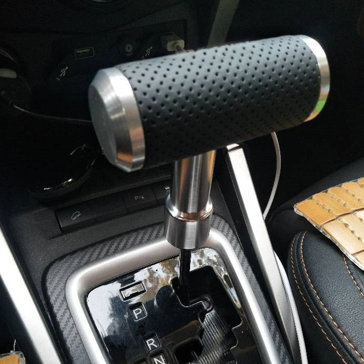 Silver T-shaped gear shift knob with black perforated grip installed in a car