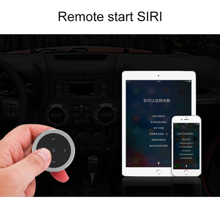 Black circular Bluetooth remote controller held near the vehicle dashboard