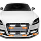 Front of a white car with integrated LED daytime running lights on