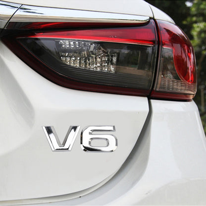 Silver V6 shape metal car body sticker on white car panel
