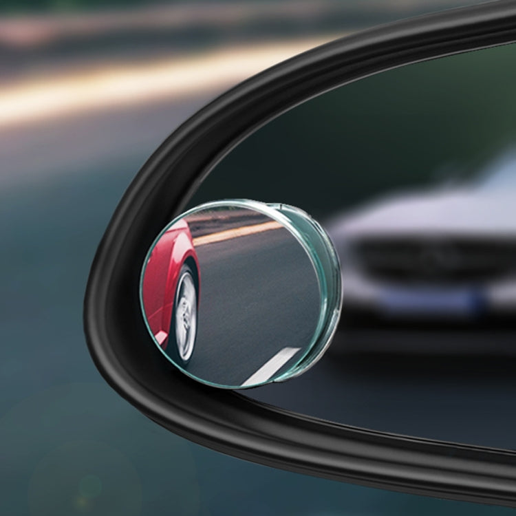 Close-up of round blind spot mirror showing reflected vehicles through glass