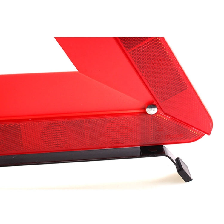 Red reflective warning triangle corner with textured lens and black base legs
