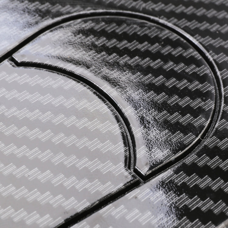 Close-up of oval carbon-fiber style car lock body sticker, black with white edge line