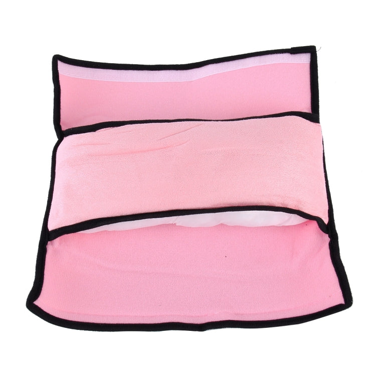 Pink car seat neck support pillow with black edging and lighter inner lining