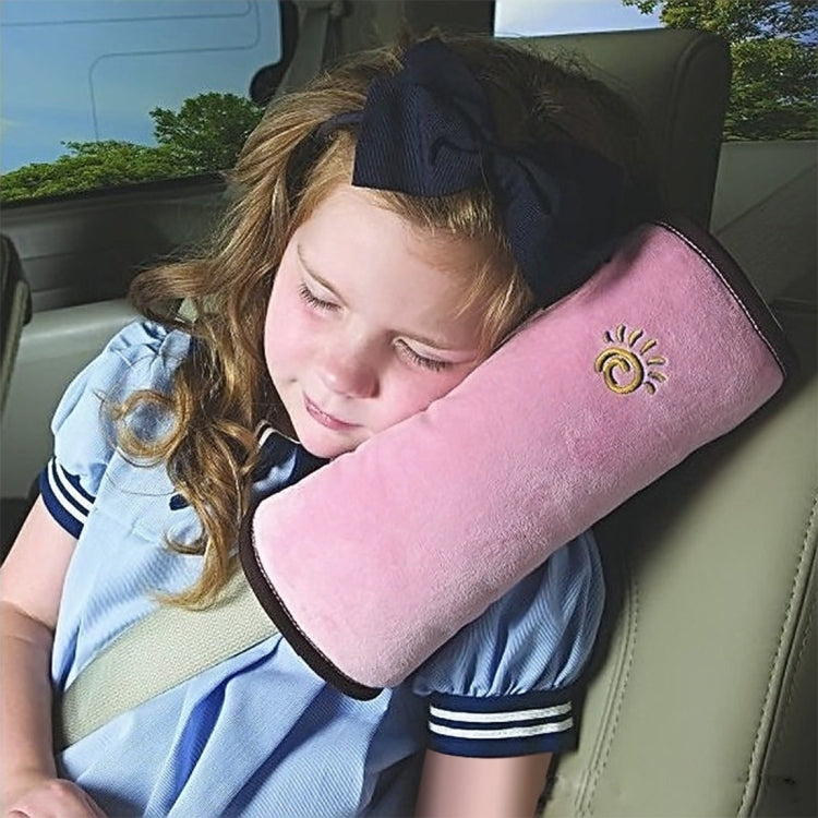 Pink car seat headrest neck support pillow in use behind a seated child