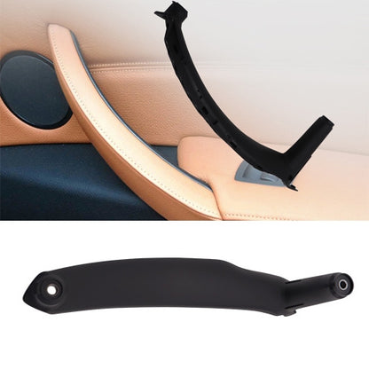 Car door armrest pull handle in light beige on interior panel with trim stitching