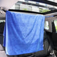 Blue elastic rope strap holding a towel across the car interior