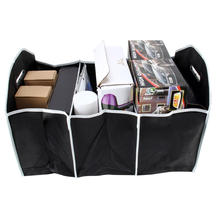 Foldable black trunk organizer box with four inner compartments holding items