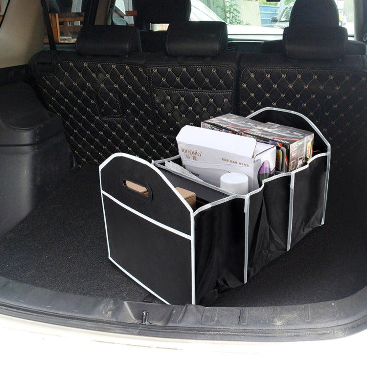 Foldable black trunk organizer storage box in vehicle cargo area with open compartments