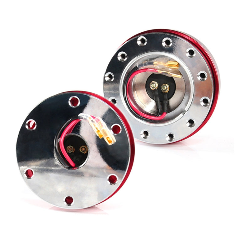 Quick-release steering wheel hub adapter halves with exposed wiring and bolt holes