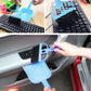 Blue mini brush and dustpan used to clean dust from car keyboard keys
