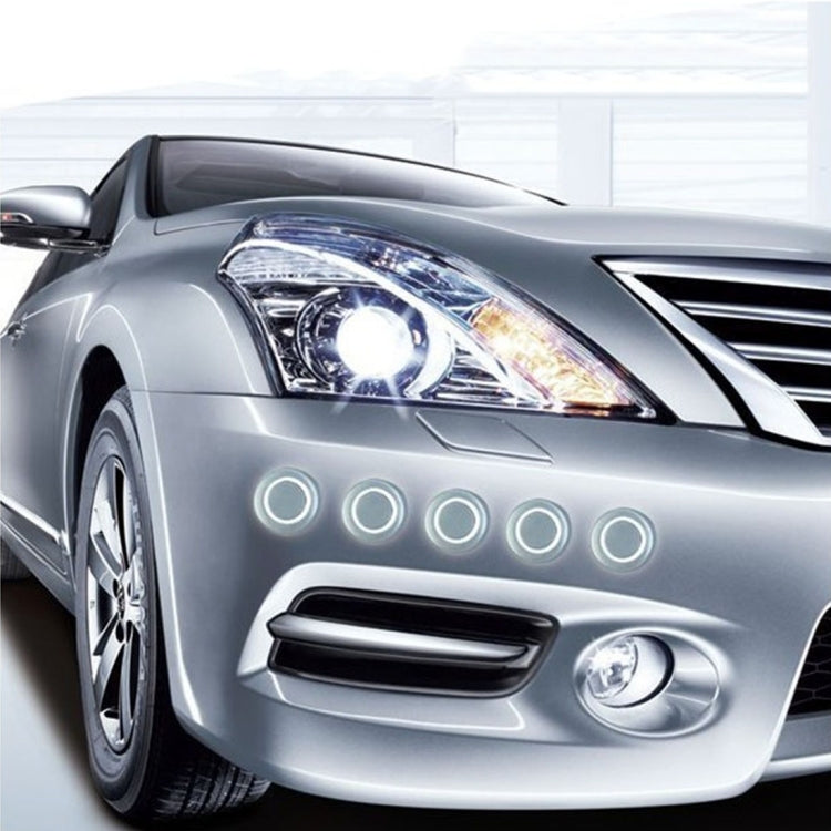 Round anti-collision stickers on car front, black centers with white ring borders