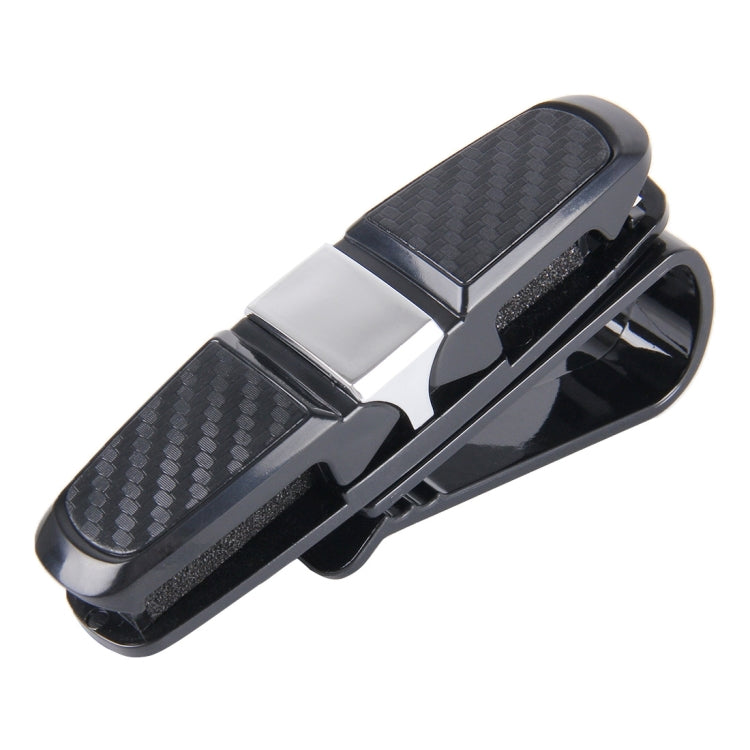 Vehicle mounted glasses clip with black carbon-fiber patterned body and metal base