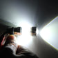LED car light bulb shining bright white, visible beam from the clear lens