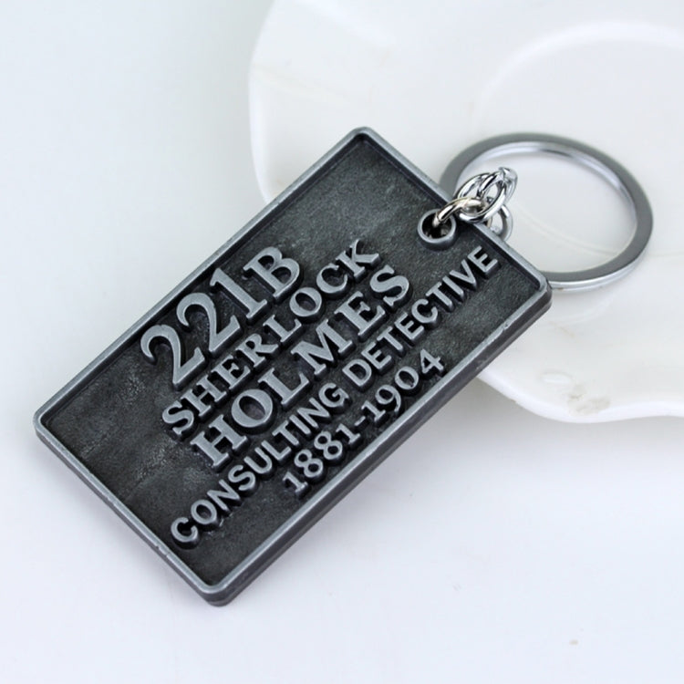 Metal keychain pendant with 221B Sherlock Holmes inscription and split-ring clasp
