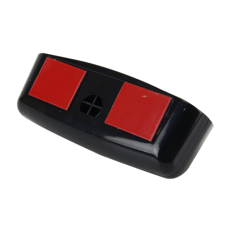 Black mirror housing with two red adhesive pads and central mounting opening