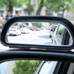 Close-up of wide-angle auxiliary side mirror reflecting street traffic