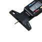 Close-up of black digital tire tread depth gauge with LCD screen and inch/mm label