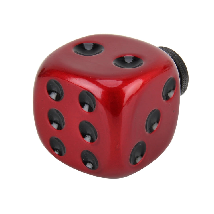 Red dice-shaped gear shift knob with multiple black oval openings