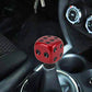 Red dice-shaped gear shift knob installed on a car shift boot