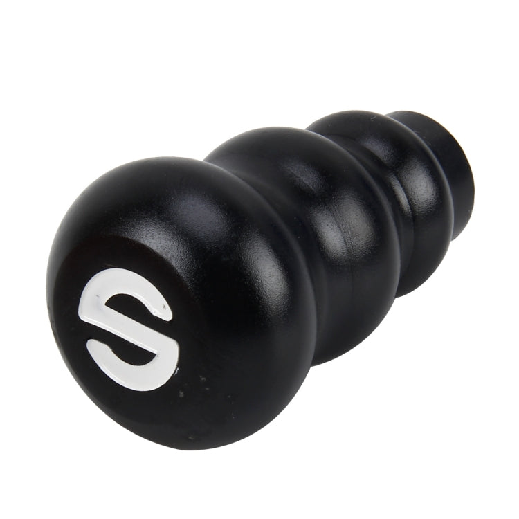 Black gourd-style gear shift knob showing white shift emblem and rounded ridges