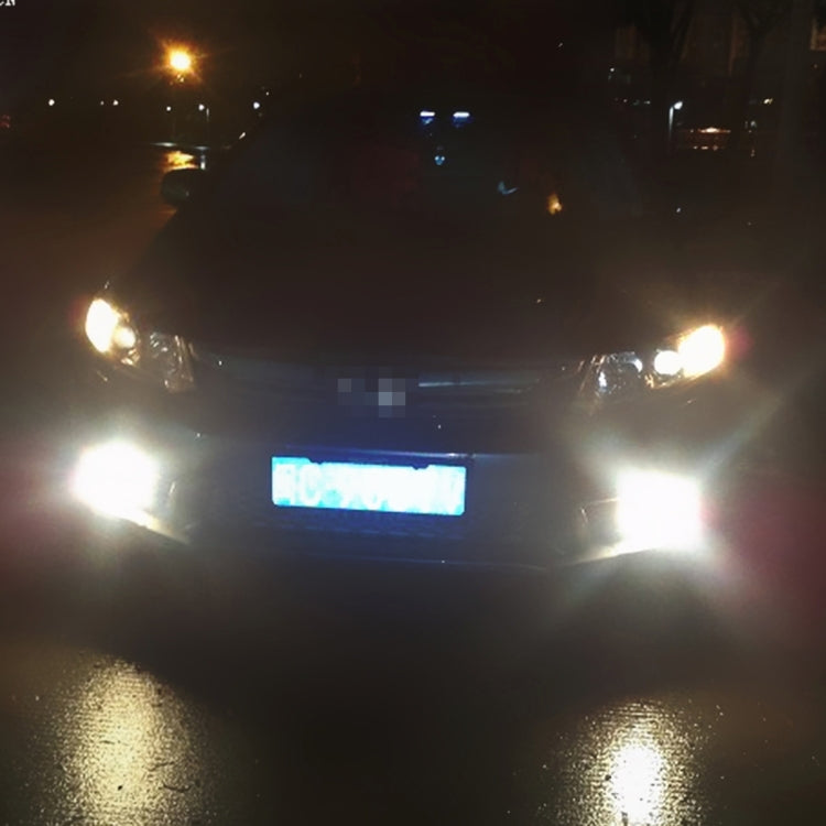 9006 LED fog light bulb shining a strong white light beam in a wide cone