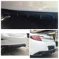 Black rear bumper lip diffuser installed on car rear, shark-fin style fins visible