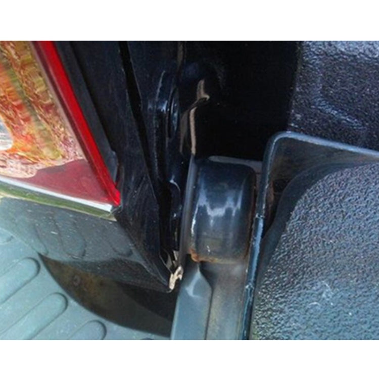 Black tailgate hinge pivot bushing insert installed near vehicle latch area