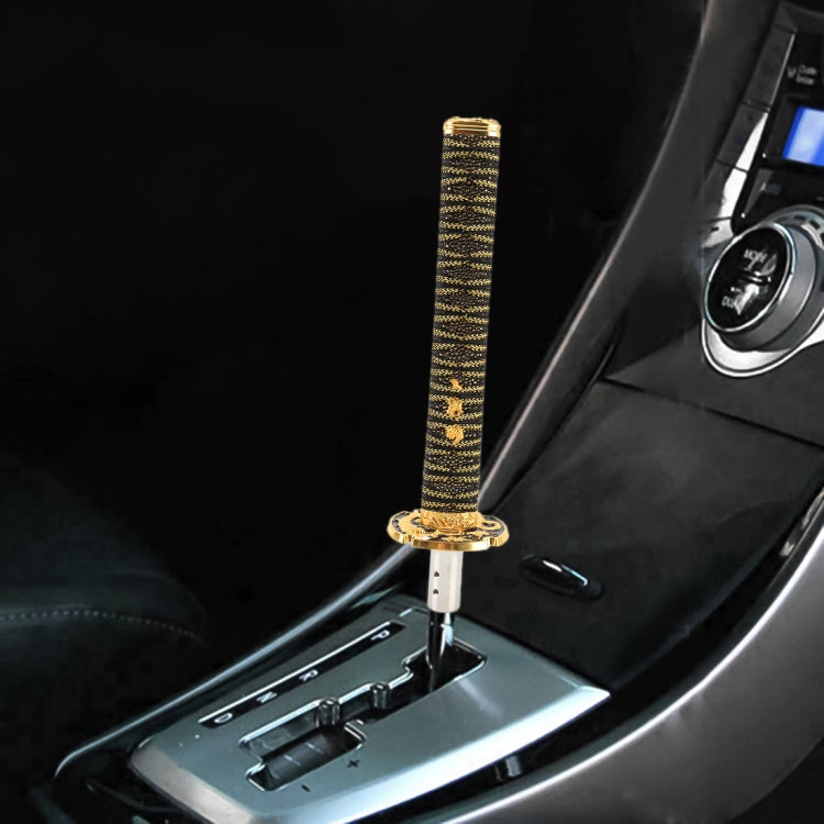 Gear shift knob with gold braided grip sleeve and chrome mounting base in console