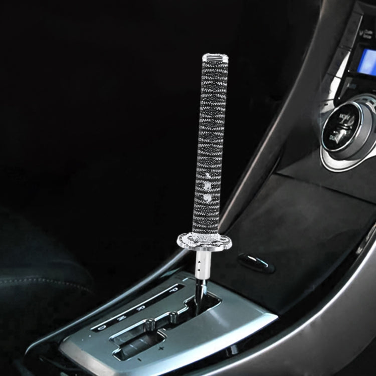 Universal gear shift knob with black braided sleeve and chrome base in car interior