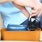 Orange portable car cup holder trash can organizer holding small items and eyewear