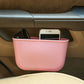 Pink portable car cup holder trash can bin holding a smartphone and eyeglasses